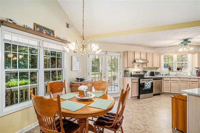 a view of a dining room with furniture large windows and wooden floor