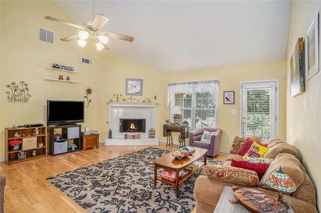 a living room with furniture a fireplace and a flat screen tv