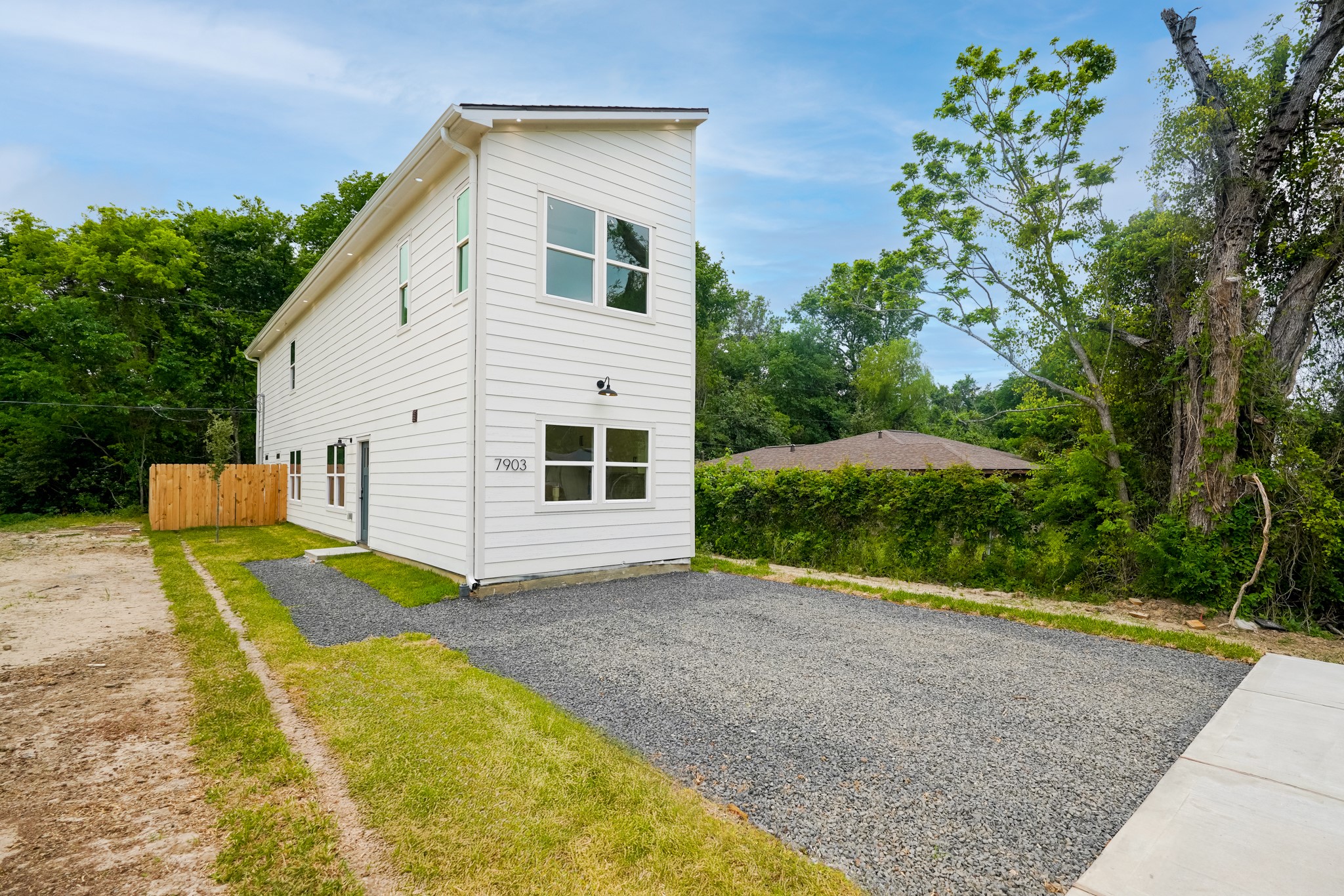 a view of a house with backyard and trees