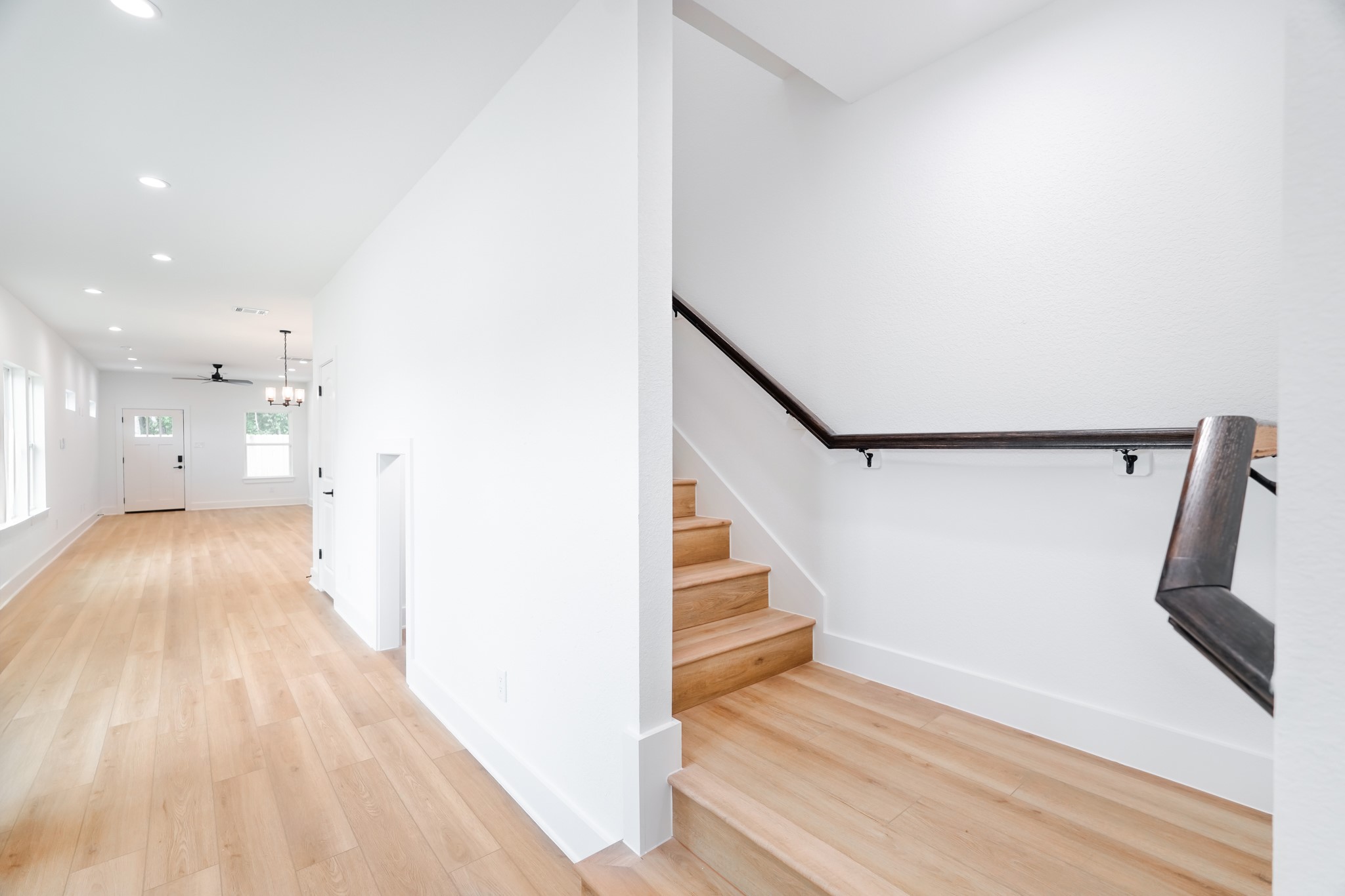 7903 Sunnyhill Street Houston, TX 77088 - Photo 16 of 33 a view of entryway and hall with wooden floor