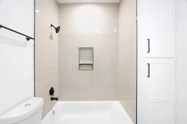 a bathroom with a bathtub and shower