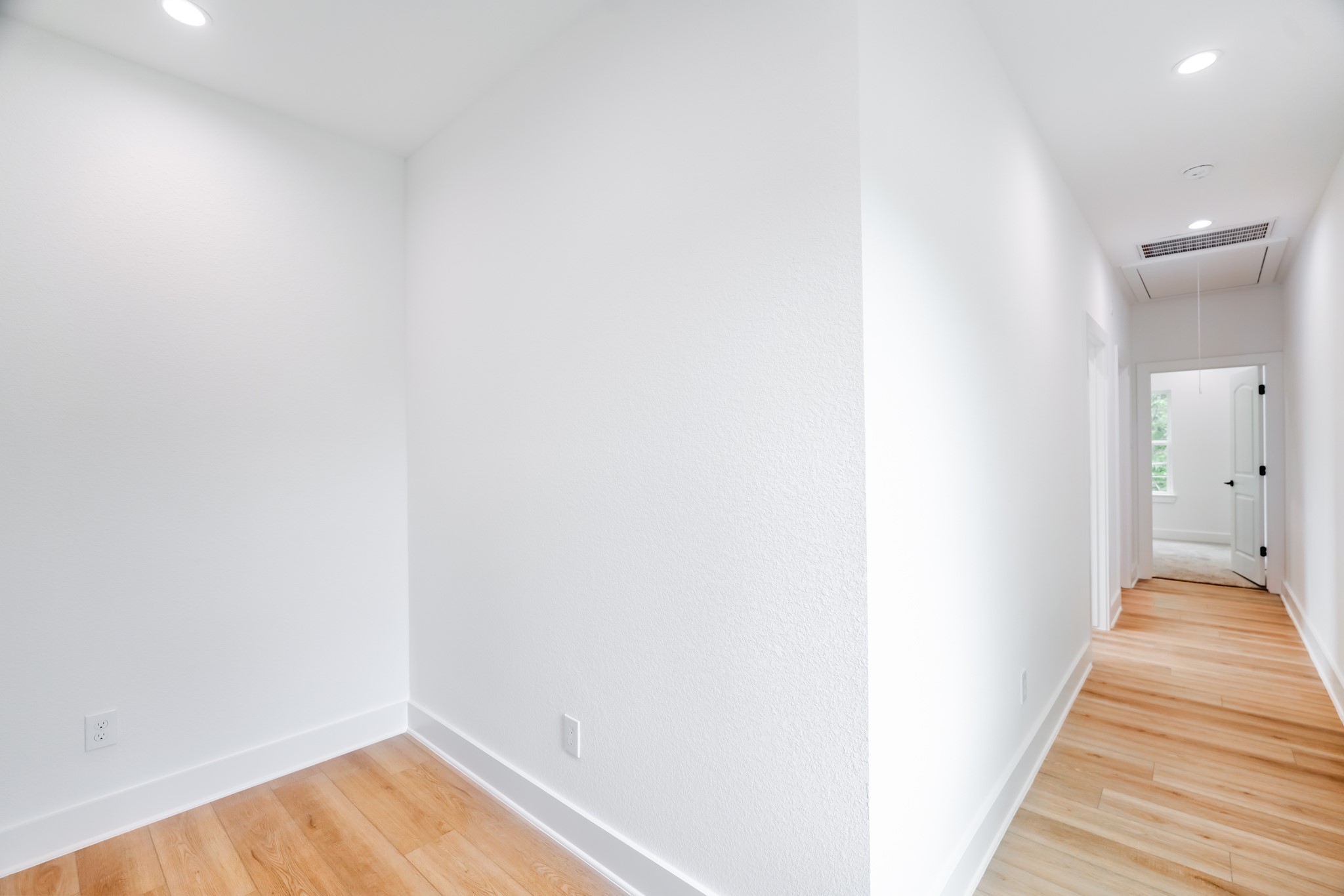 7903 Sunnyhill Street Houston, TX 77088 - Photo 24 of 33 a view of a hallway with wooden floor and a bathroom