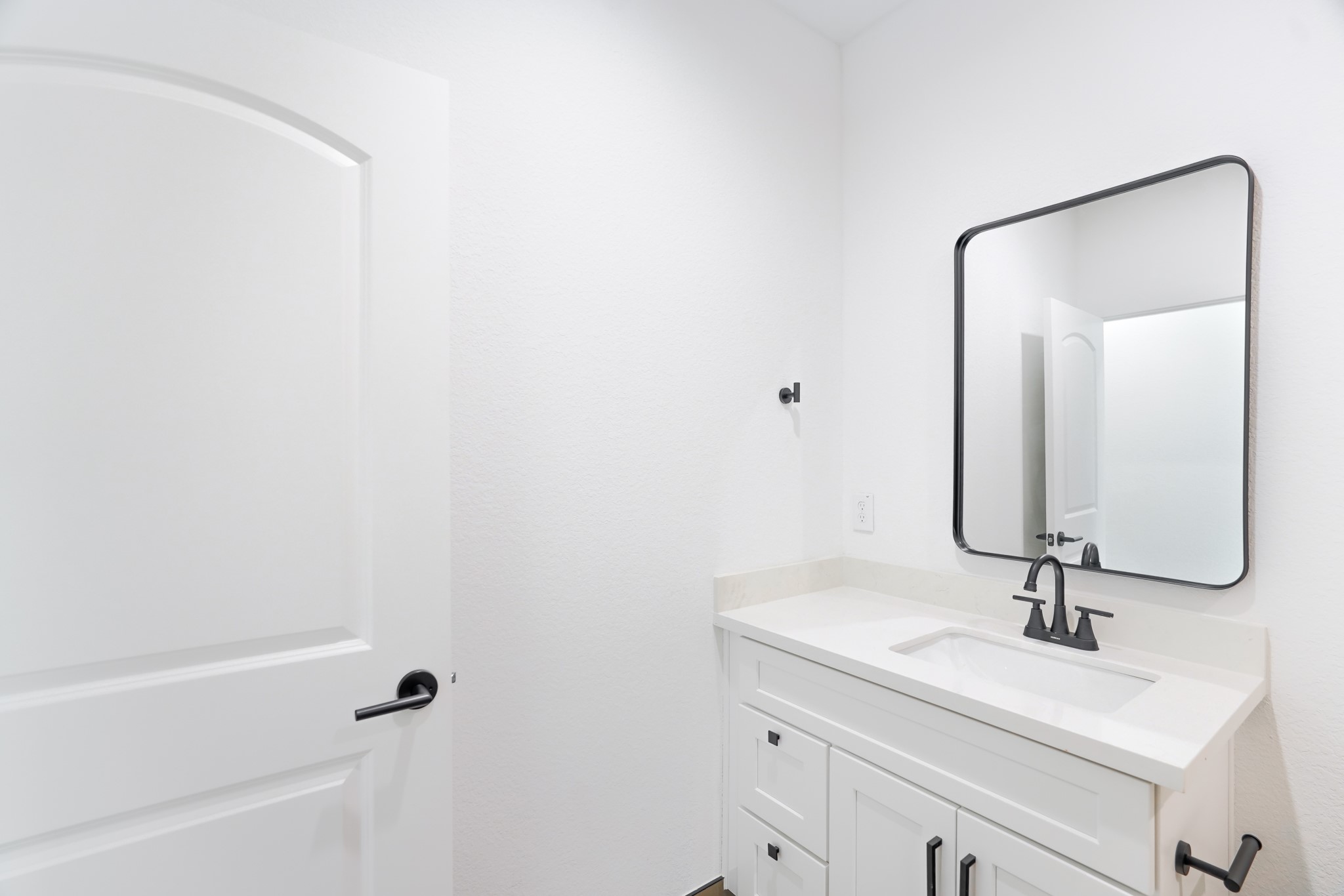 7903 Sunnyhill Street Houston, TX 77088 - Photo 27 of 33 a bathroom with a sink and a mirror