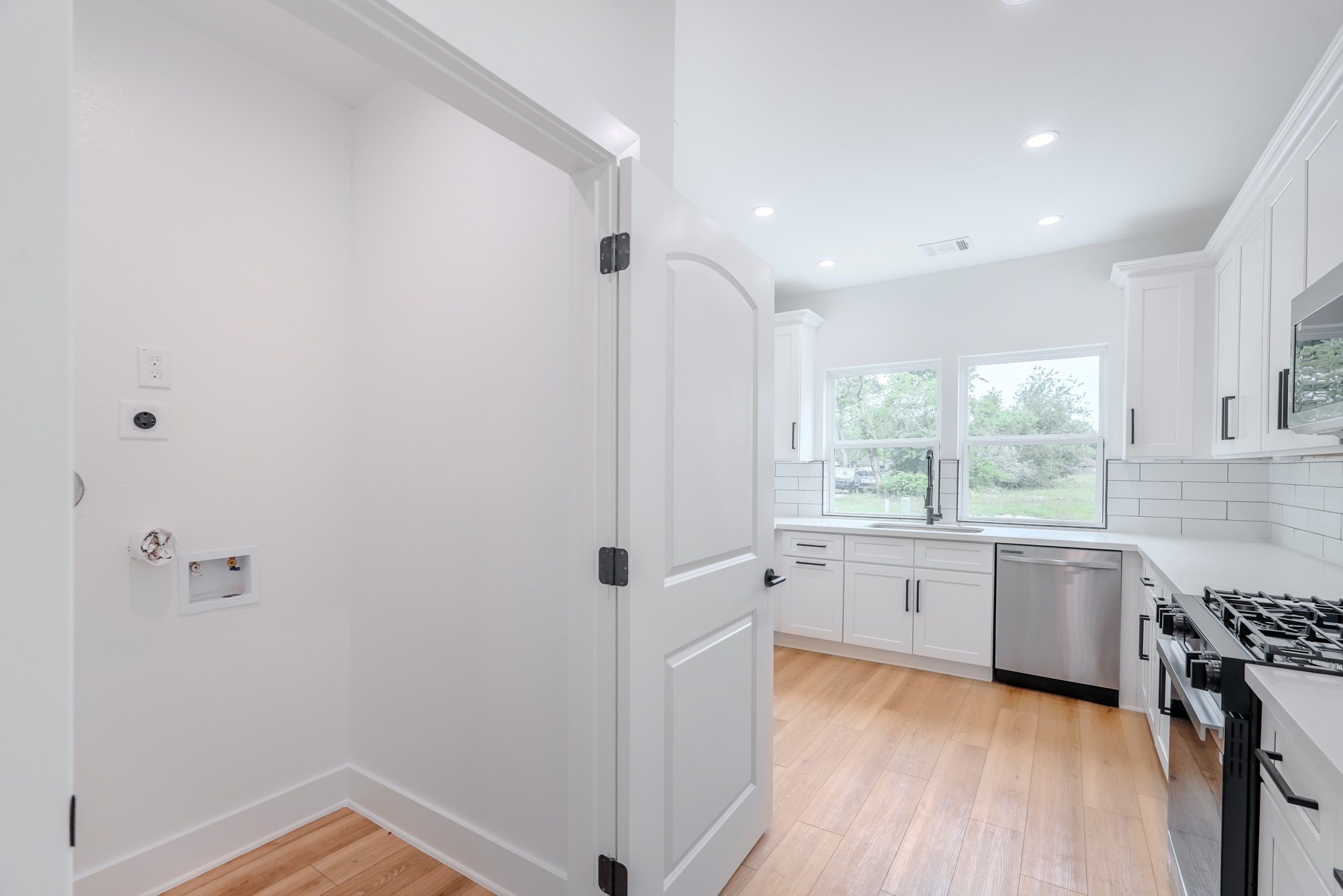 7903 Sunnyhill Street Houston, TX 77088 - Photo 5 of 33 a bathroom with a granite countertop sink a large mirror and a bathtub