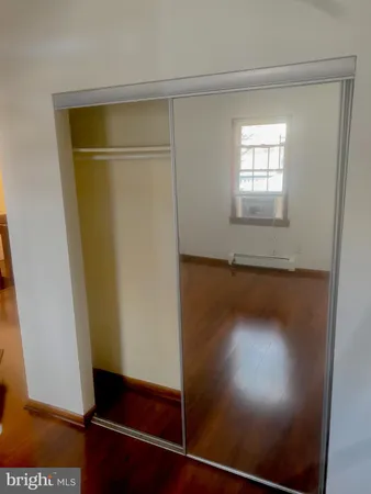 a view of a livingroom with wooden floor and a fireplace