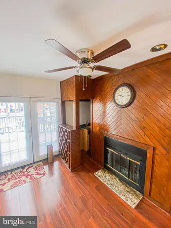 a view of a room with wooden floor and white walls