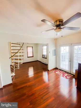 a view of water heater room with wooden floor