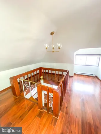 a kitchen with stainless steel appliances a refrigerator and wooden floor