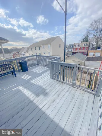 a view of a balcony with wooden floor and fence