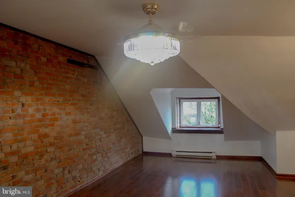 a view of a livingroom with wooden floor and a ceiling fan