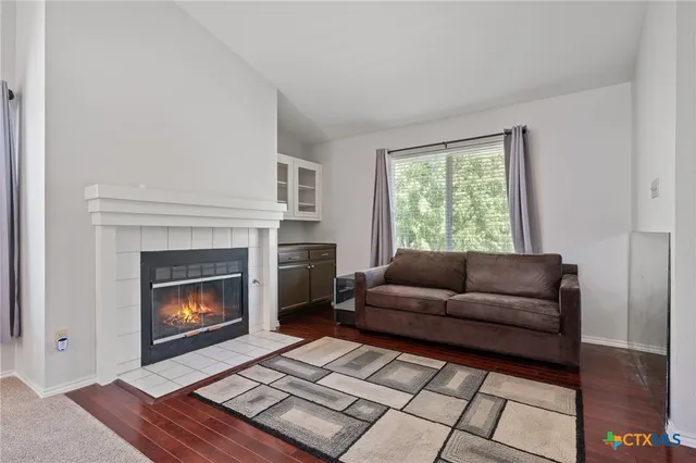 a living room with furniture and a fireplace