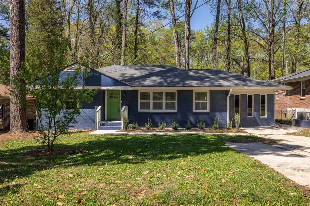 1842 Longdale Drive Decatur, GA 30032 - Photo 1 of 1 a front view of a house with a yard table and chairs