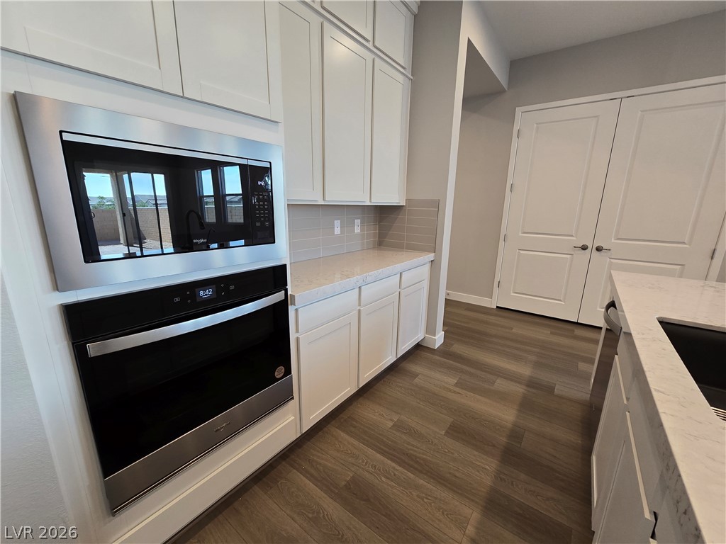 852 Weston Ridge Street Henderson, NV 89011 - Photo 6 of 28 Modern kitchen with sleek built-in appliances and abundant storage solutions.