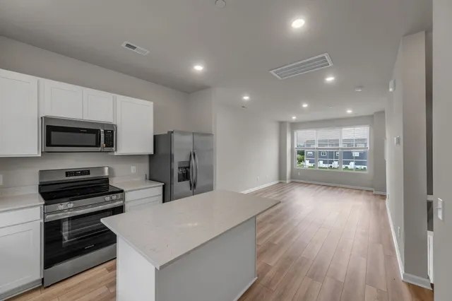 a view of kitchen with microwave and cabinets