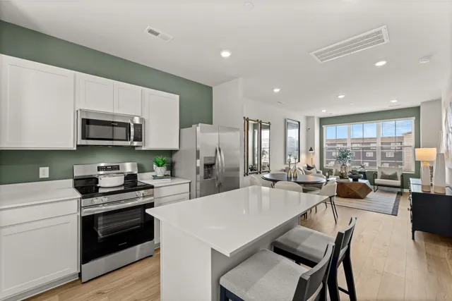 a kitchen with sink a microwave and refrigerator
