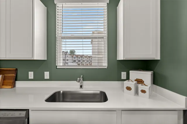 a kitchen with a sink and a stove top oven