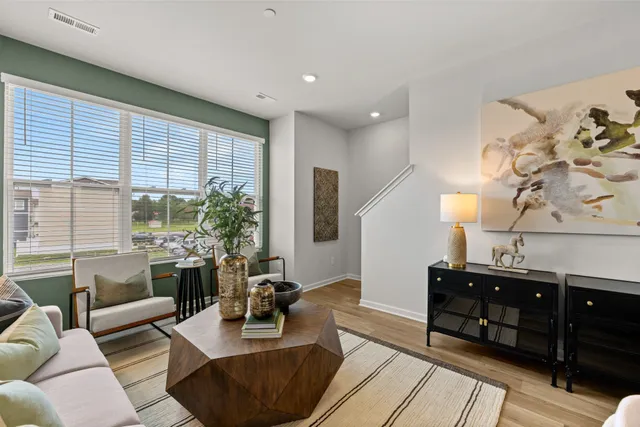 a living room with furniture and large windows