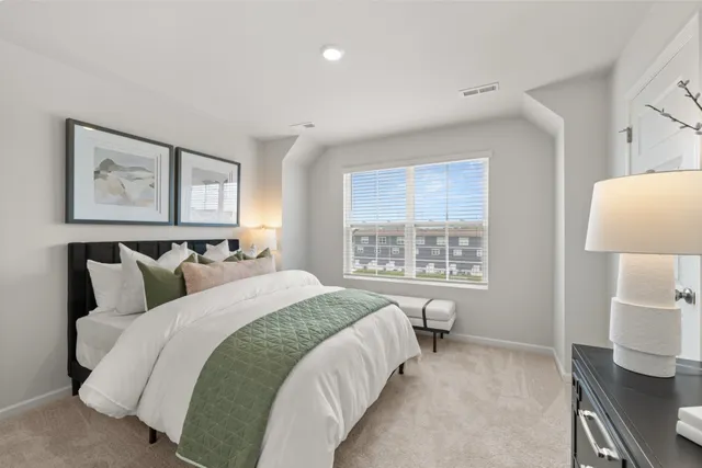 a bedroom with a bed and window