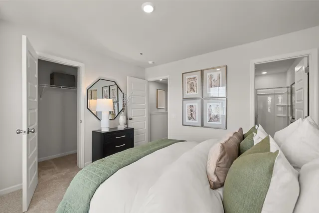 a bathroom with a shower sink vanity mirror and toilet