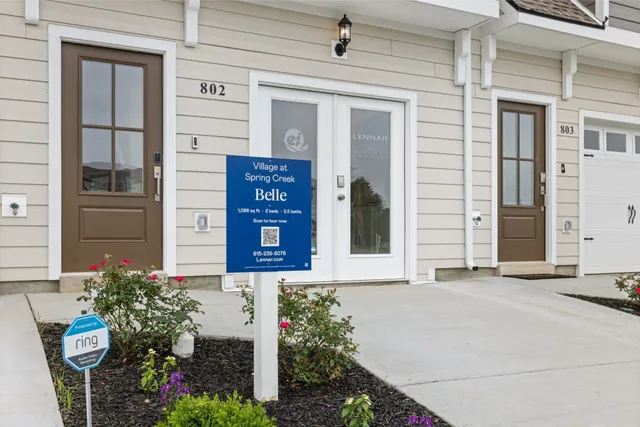 a view of a house with backyard and a tree