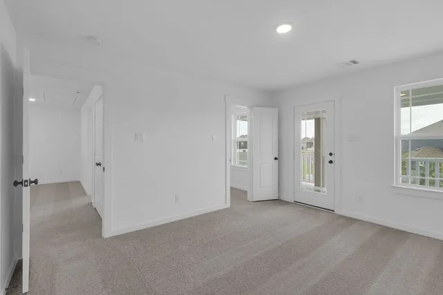 an empty room with a ceiling fan and a window