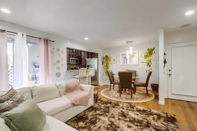 a living room with furniture and view of kitchen