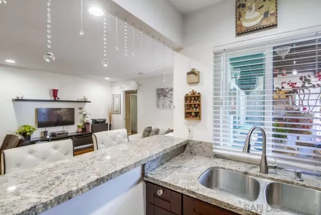 a kitchen with sink refrigerator and microwave