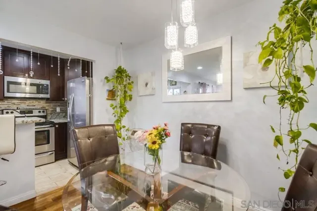 a dining room filled chandelier and wooden floor