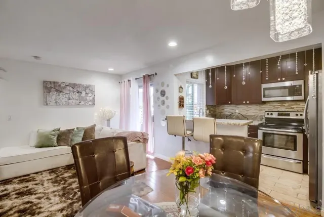 a kitchen with stainless steel appliances granite countertop a refrigerator and a stove top oven