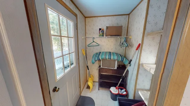 an empty room with wooden floor and a bathroom