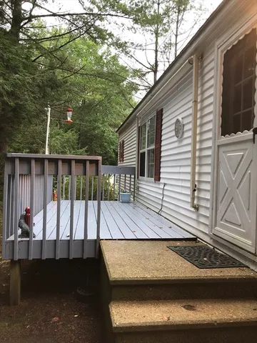 a view of a balcony with floor to ceiling window and wooden floor