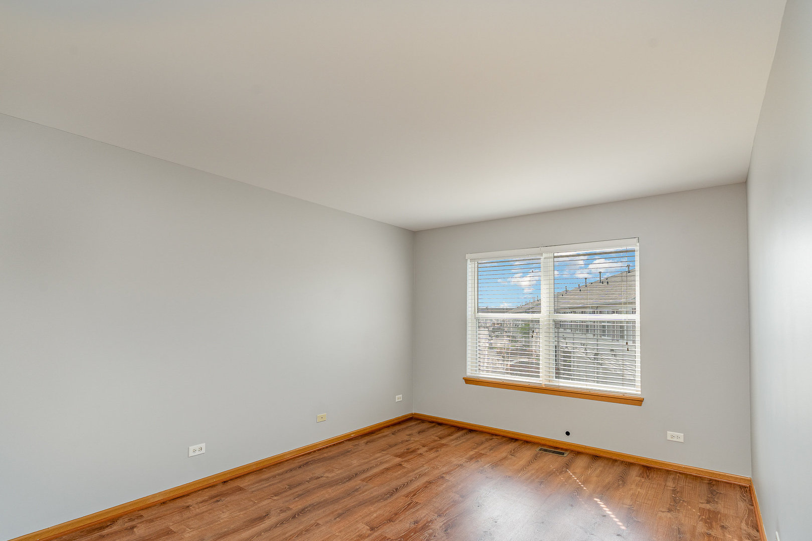 2255 Georgetown Circle Aurora, IL 60503 - Photo 8 of 14 an empty room with wooden floor and windows
