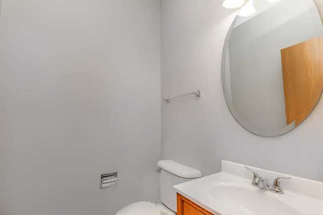 a bathroom with a sink mirror and toilet