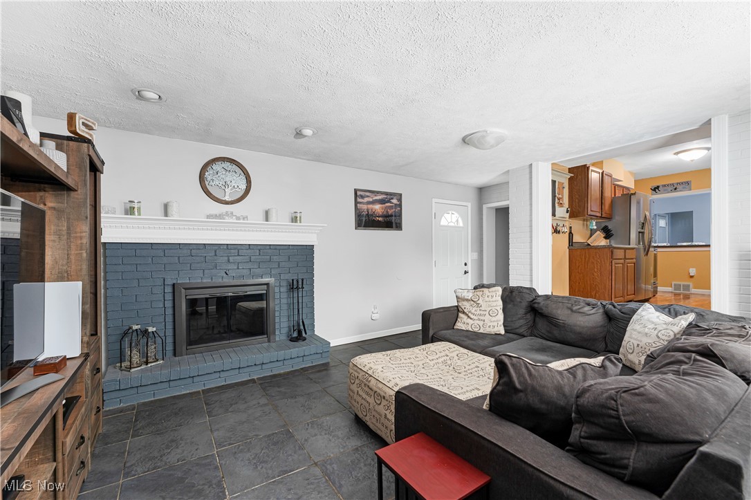 6254 Stanbury Road Parma, OH 44129 - Photo 23 of 44 Living room featuring a textured ceiling and a fireplace