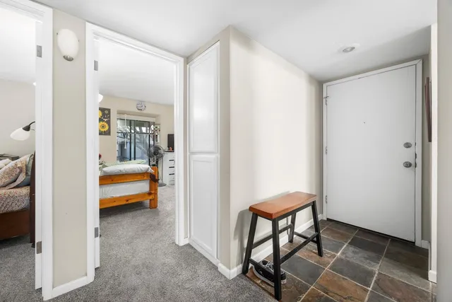 a bedroom with a bed and a chair