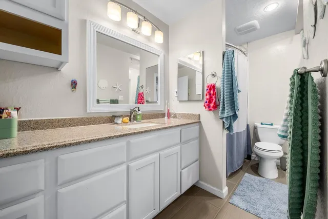 a utility room with cabinets washer and dryer