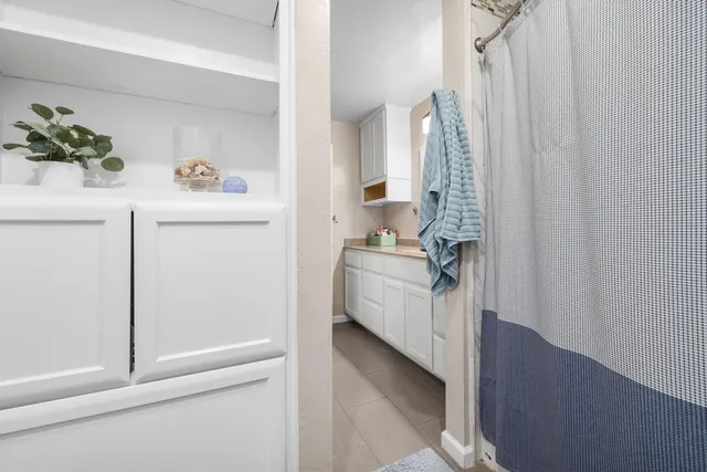a bathroom with a toilet and a shower curtain
