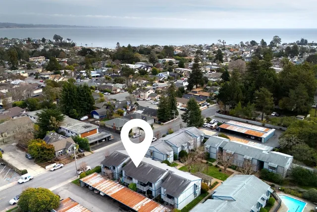 an aerial view of a house with a swimming pool outdoor seating and yard