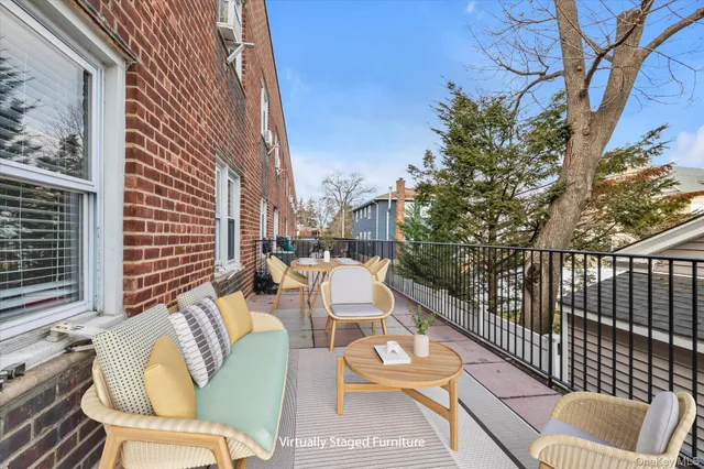 a view of a patio with couches table and chairs and potted plants