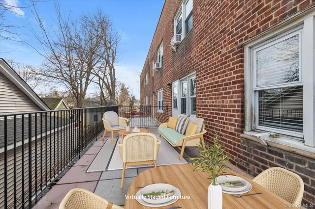 a view of a patio with couches table and chairs and wooden floor