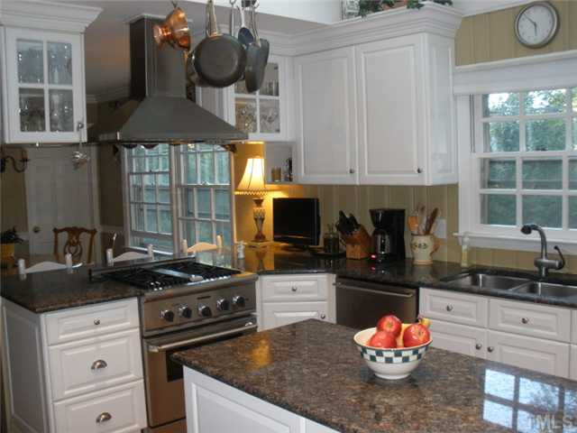 2633 Lakeview Drive Raleigh, NC 27608 - Photo 5 of 18 Vaulted ceiling, sky lights, hardwood floors, hung cabinets, crown molding. It is a pleasure to cook in this kitchen. Kitchen