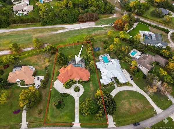 an aerial view of residential house with outdoor space and pool