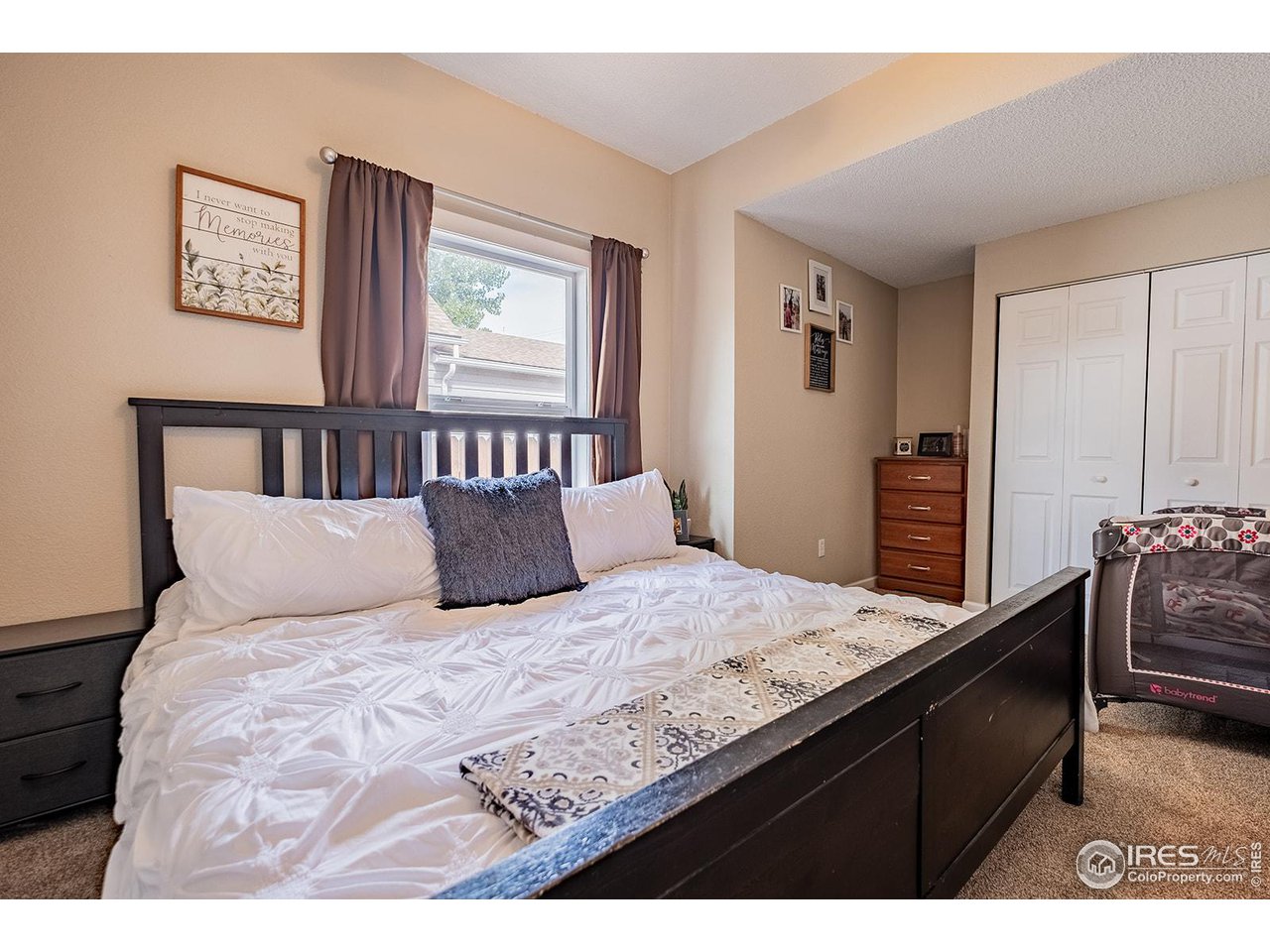 428 Douglas Street Sterling, CO 80751 - Photo 11 of 14 a bedroom with a bed and wooden floor