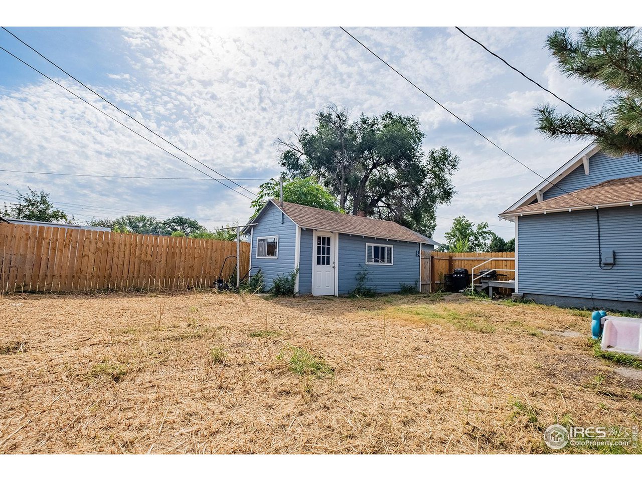 428 Douglas Street Sterling, CO 80751 - Photo 13 of 14 a backyard of a house with wooden fence