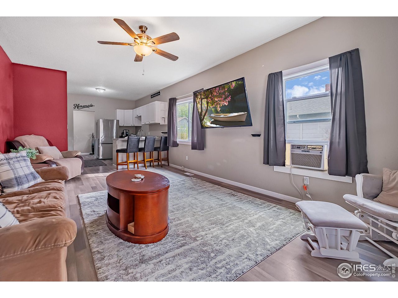 428 Douglas Street Sterling, CO 80751 - Photo 3 of 14 a living room with furniture a rug and a window