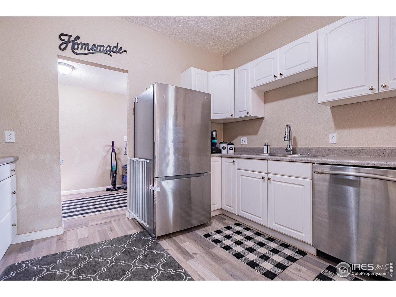 428 Douglas Street Sterling, CO 80751 - Photo 6 of 14 a kitchen with a refrigerator a sink and dishwasher