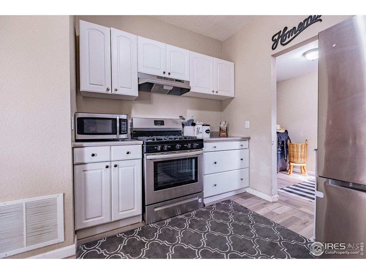428 Douglas Street Sterling, CO 80751 - Photo 7 of 14 a kitchen with stainless steel appliances granite countertop a stove and a refrigerator