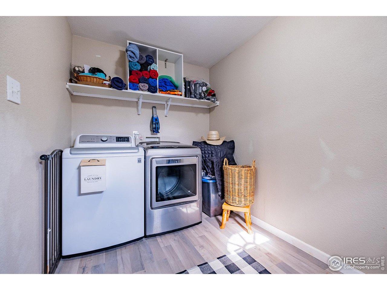 428 Douglas Street Sterling, CO 80751 - Photo 8 of 14 a utility room with dryer washer and a view of living room