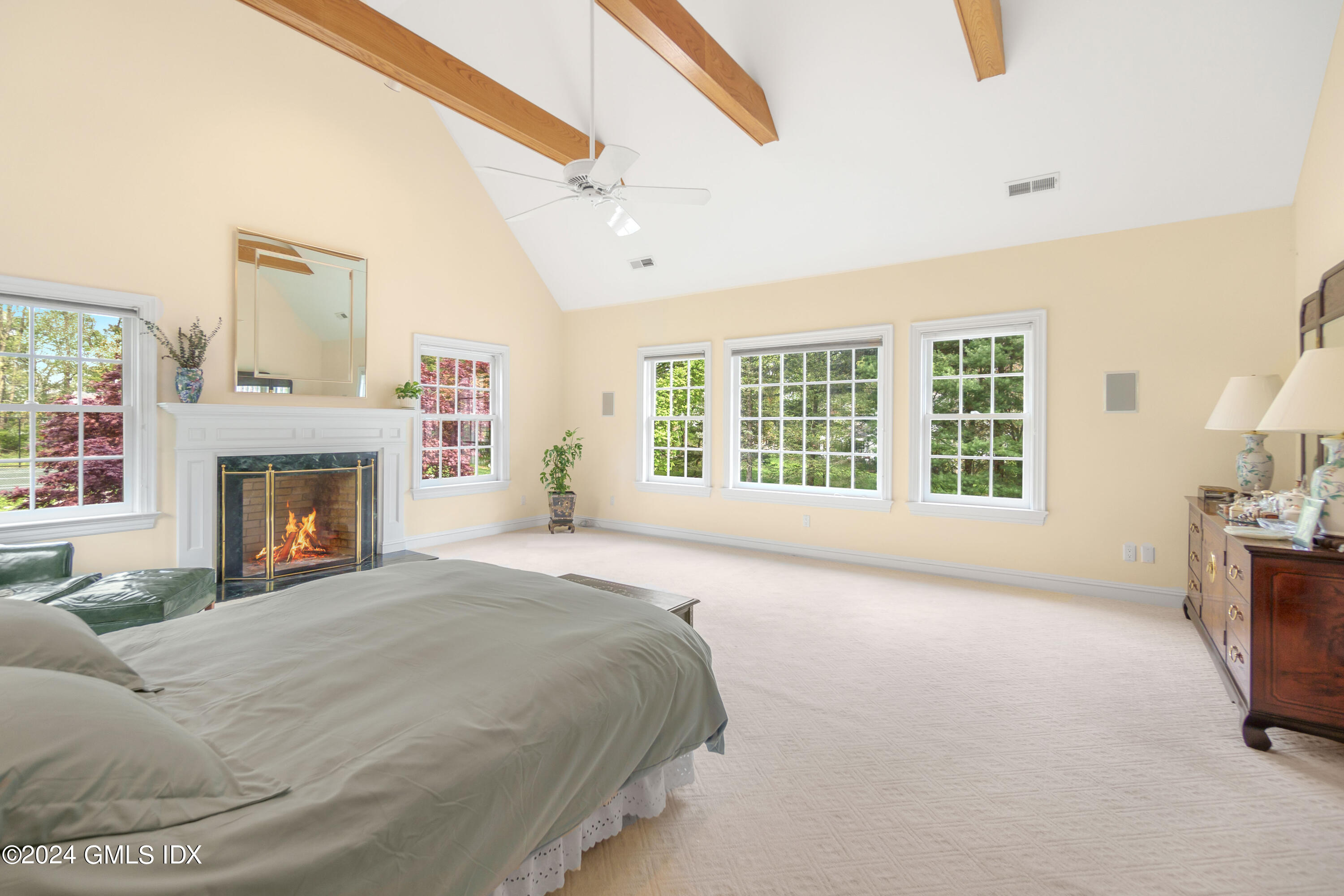 719 Ponus Ridge Road New Canaan, CT 06840 - Photo 12 of 38 a spacious bedroom with a bed and a fireplace