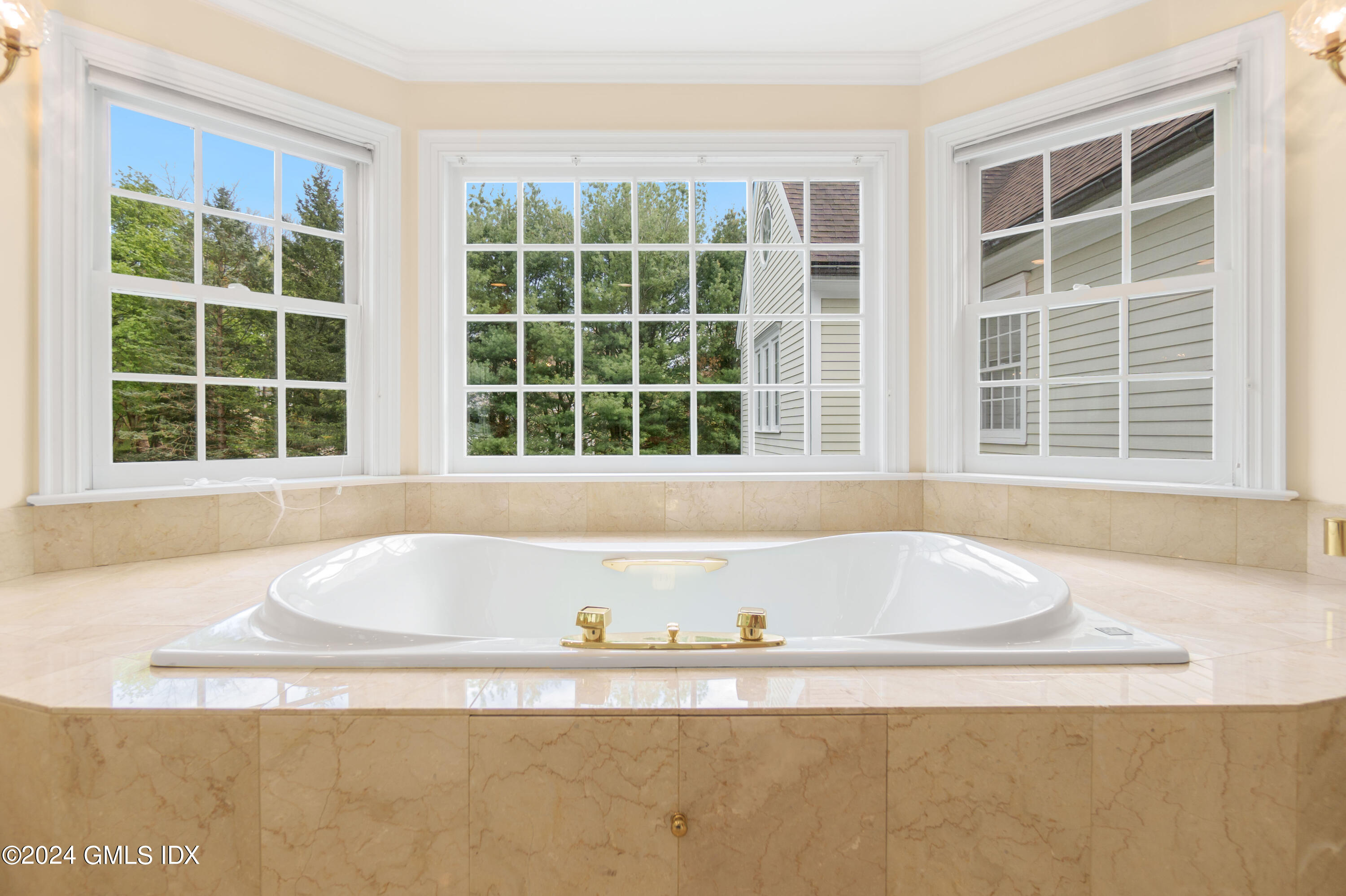 719 Ponus Ridge Road New Canaan, CT 06840 - Photo 14 of 38 a white bath tub sitting in a bathroom next to a window